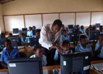 Online Picture Showing A Malawian teacher teaching students how to use a computer