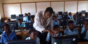 Online Picture Showing A Malawian teacher teaching students how to use a computer