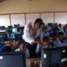 Online Picture Showing A Malawian teacher teaching students how to use a computer