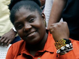 Beaded bracelets and raised fist symbolizing cultural pride of Colombia's Vice President Francia Márquez