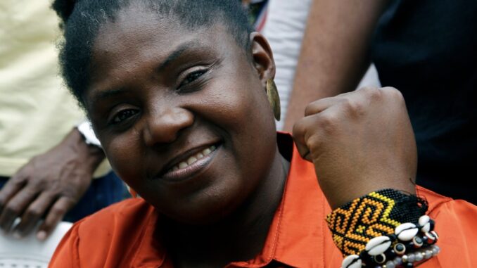 Beaded bracelets and raised fist symbolizing cultural pride of Colombia's Vice President Francia Márquez
